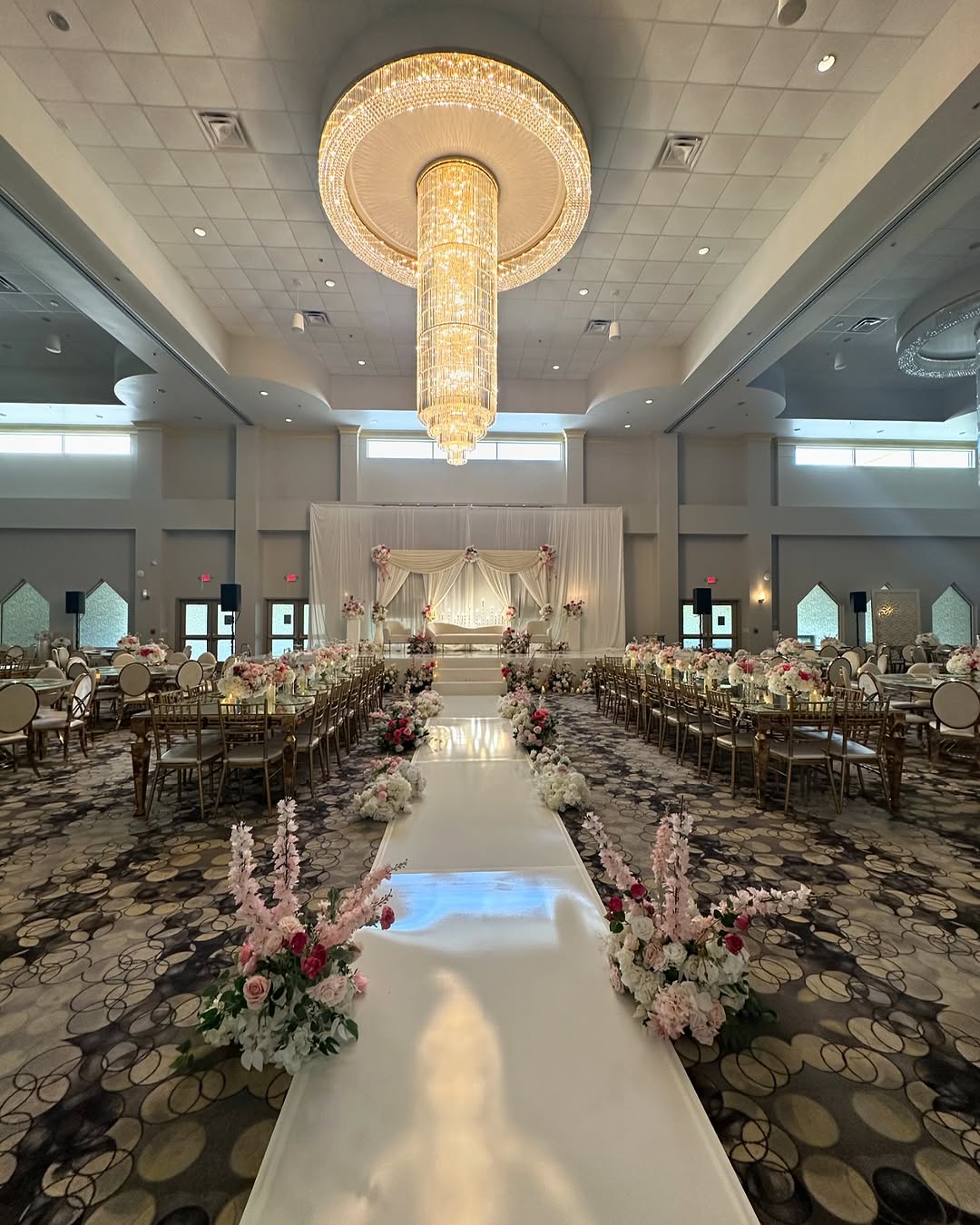 Wedding banquet seating beneath the ballroom chandelier